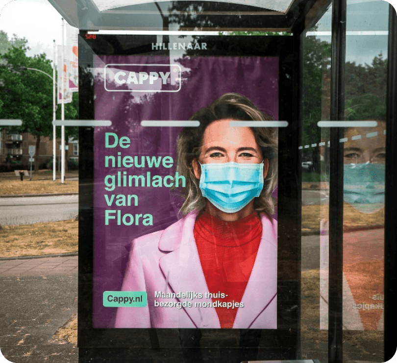A billboard advert showing a woman wearing a facemask